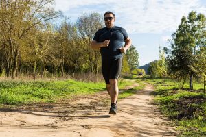 A man jogging on a trail