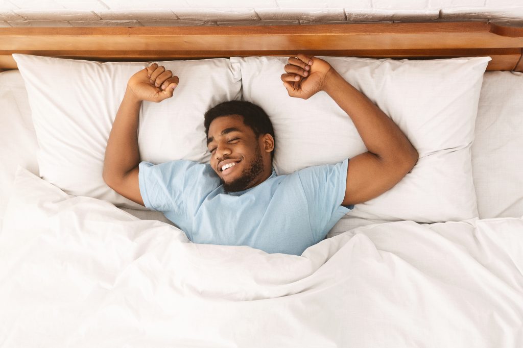 man stretching after a night of restful sleep