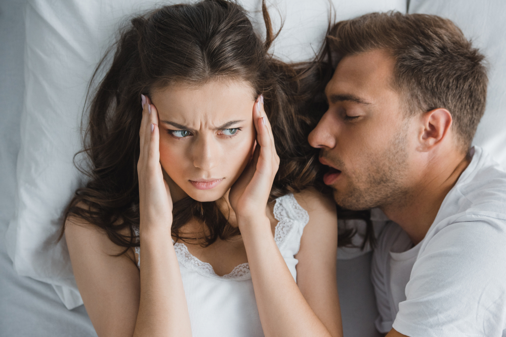 man snoring in woman's ear