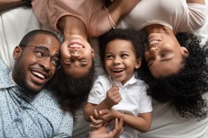 A family is comfortably in bed practicing good sleep hygiene